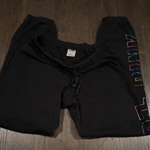 Black sweatpants with rainbow lettering